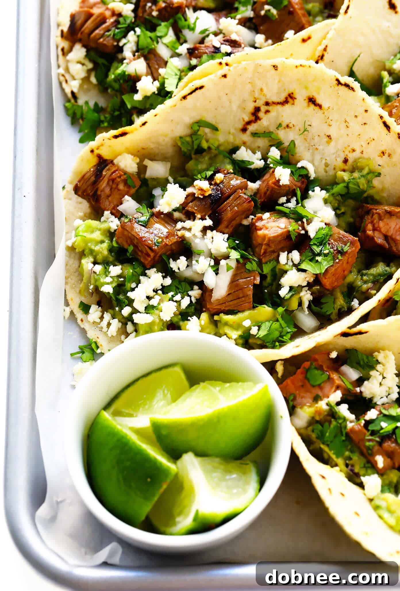My favorite recipe for street-style Mexican carne asada tacos -- made with tender marinated grilled steak, soft corn tortillas, guacamole or sliced avocado, and whatever other toppings sound good! | gimmesomeoven.com #carneasada #beef #steak #tacos #mexican #avocado #guacamole #glutenfree #dinner Carne Asada Tacos with Lime