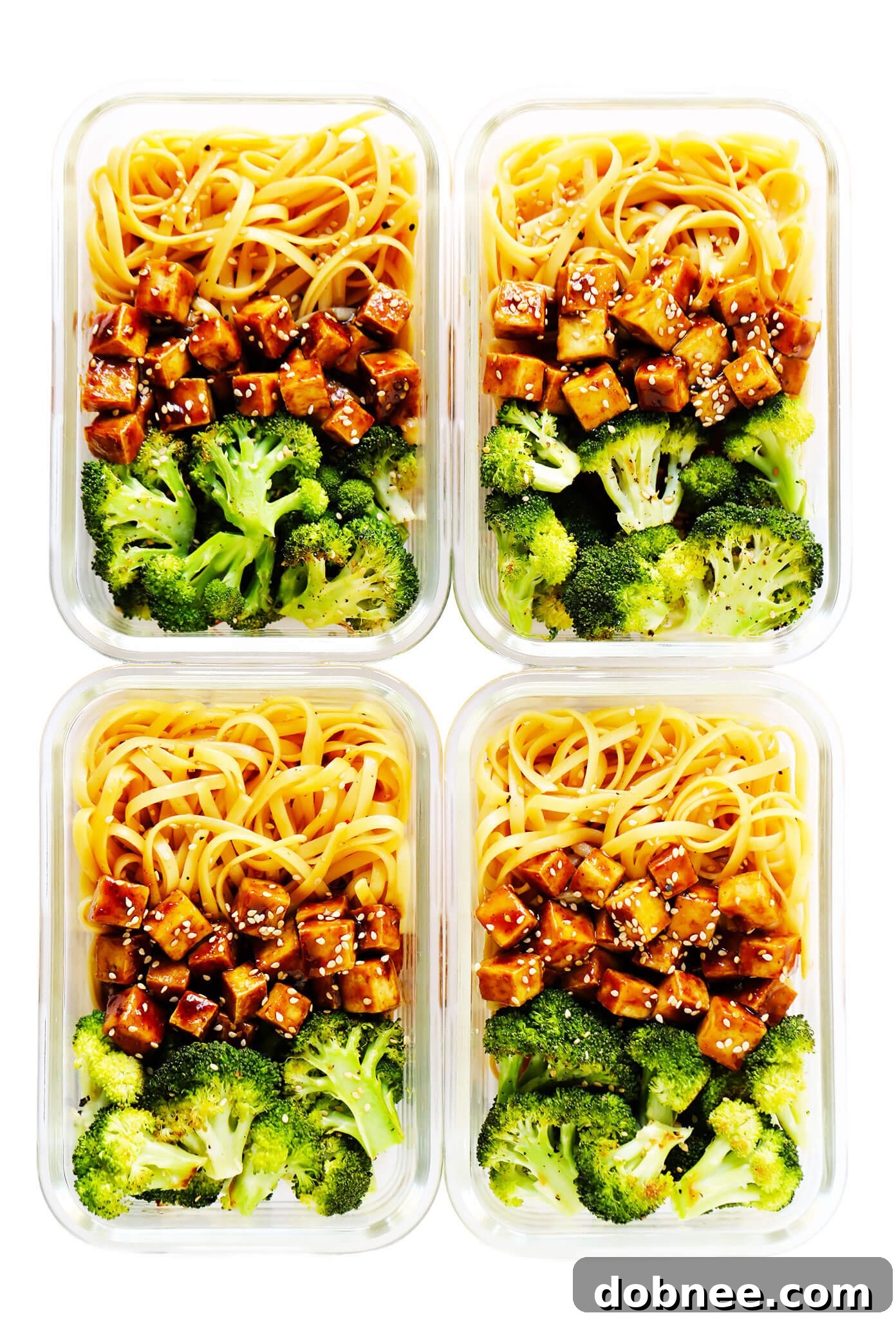 Prepared Crispy Tofu Sesame Noodle Bowls neatly arranged in meal prep containers for easy storage and portability.