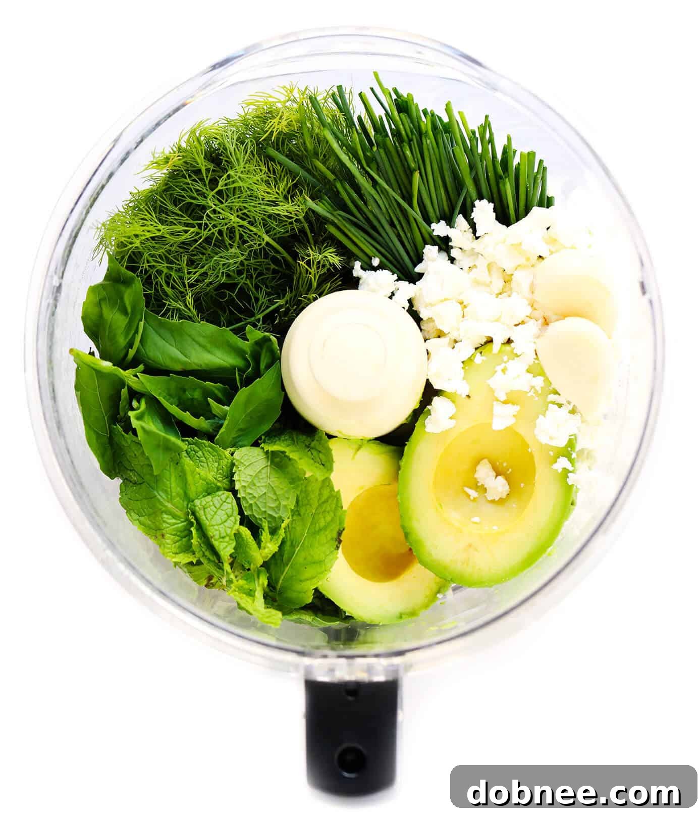 Ingredients for Green Goddess Feta Dip laid out on a cutting board