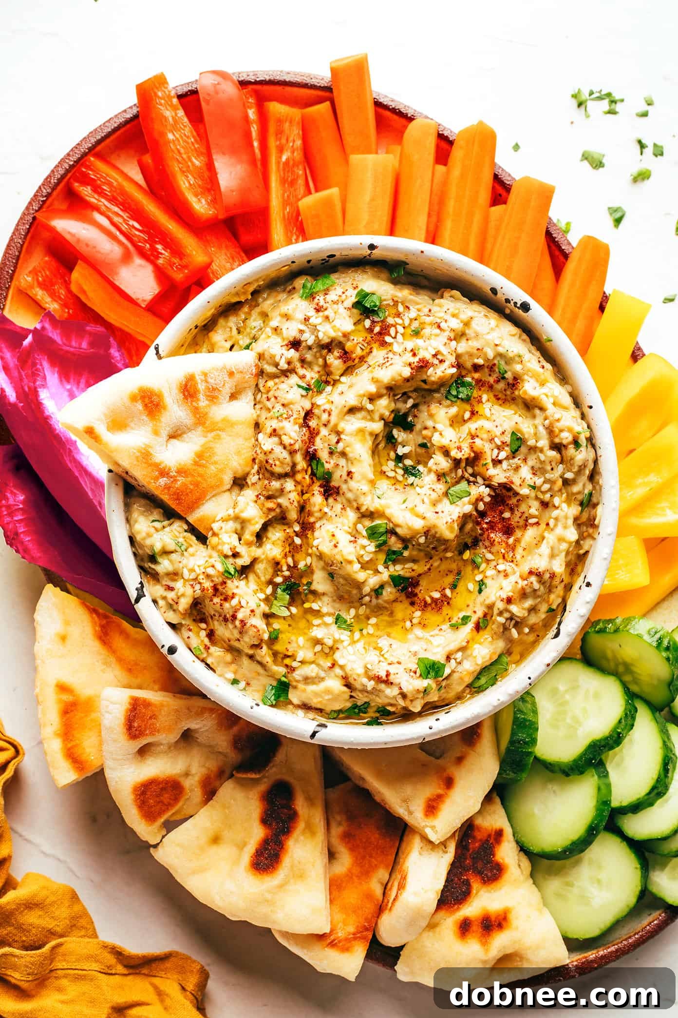 A spread of various Middle Eastern dips and snacks, including a prominent bowl of baba ganoush.