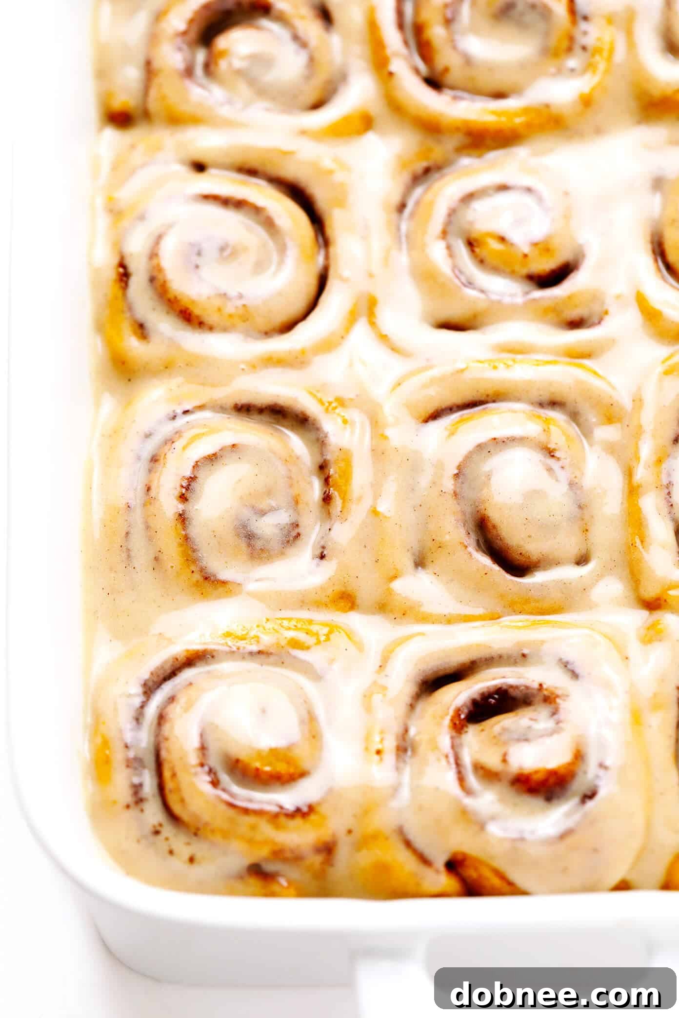 Pumpkin Cinnamon Rolls with Maple Frosting in a Baking Pan