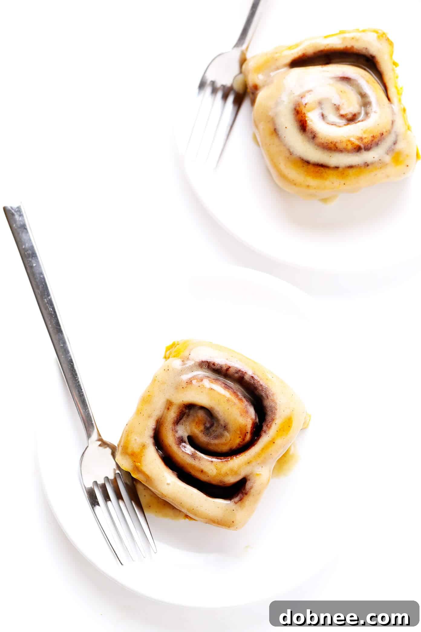 Individual Pumpkin Cinnamon Rolls on Plates with Forks