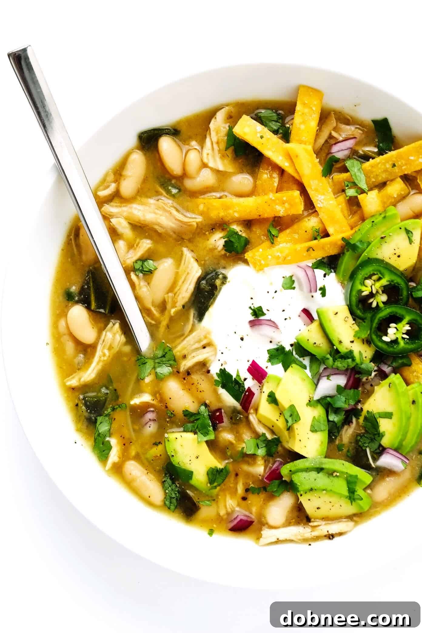 Bowl of Poblano White Chicken Chili with avocado and cilantro