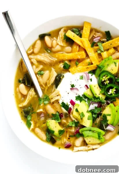 Poblano White Chicken Chili in a bowl with toppings