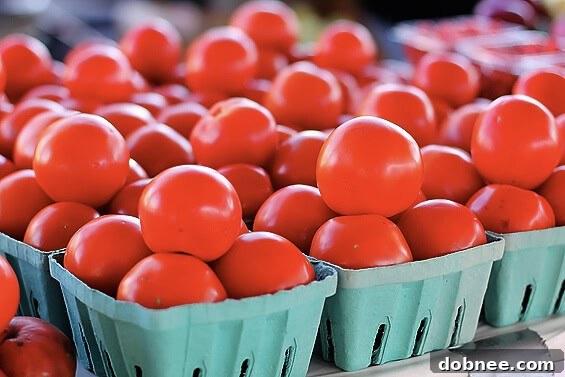 Gorgeous, ripe tomatoes in various shades of red and orange, ready for tasting