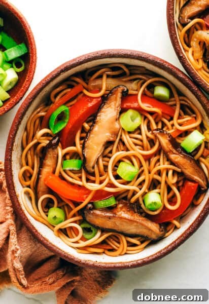 A vibrant bowl of homemade Chow Mein, garnished with green onions and ready to eat.
