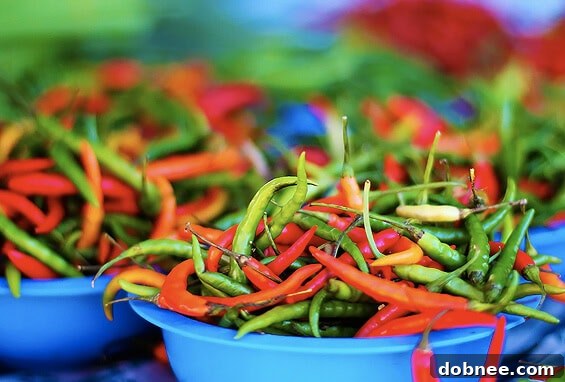 Igniting Flavors: The Fiery Allure of Hot Peppers A vibrant display of various types of hot peppers, ranging in color and size, at a farmers market stall.