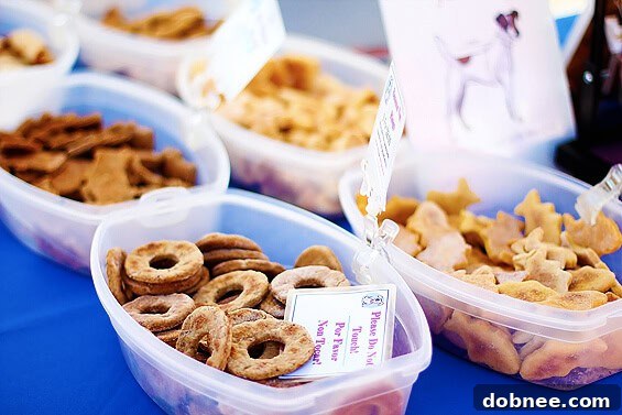 A Treat for Every Family Member: Homemade Dog Delights A charming display of homemade dog treats for sale at a market, featuring various shapes and flavors.
