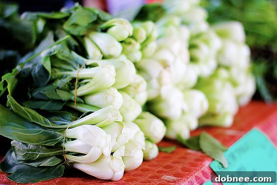 Fresh Bok Choy: A Delight for Healthy Cooking Fresh, vibrant bok choy stalks neatly displayed for sale at a farmers market, showcasing its crisp green leaves.