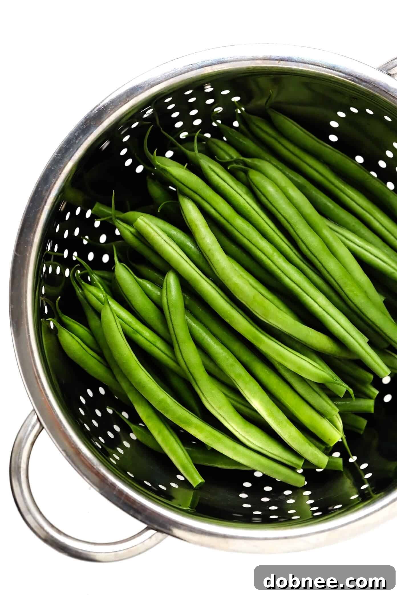 Prepping Green Beans for Sautéed Perfection Fresh Green Beans in a Strainer