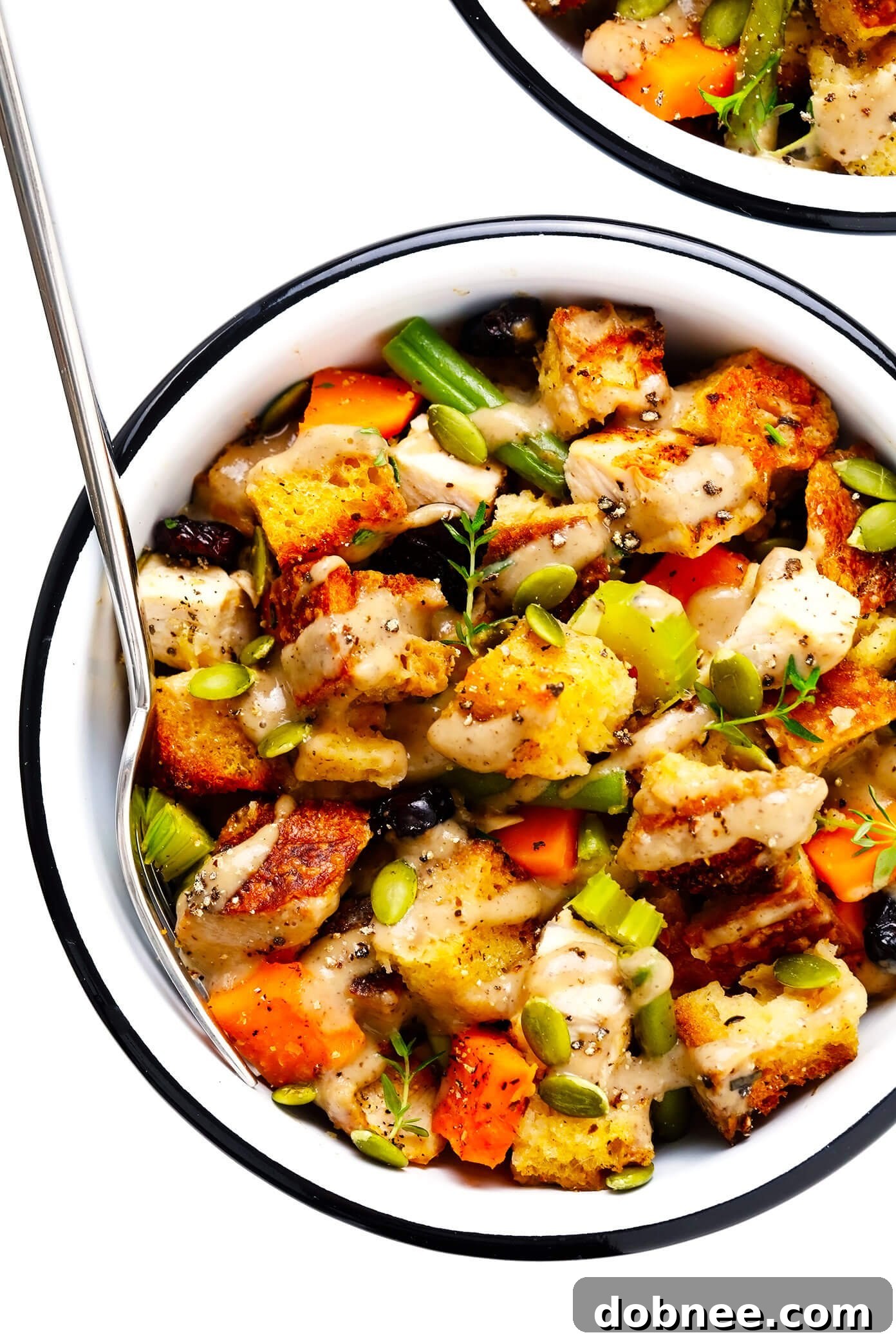 Thanksgiving Casserole served in individual bowls, garnished with gravy and fresh herbs.