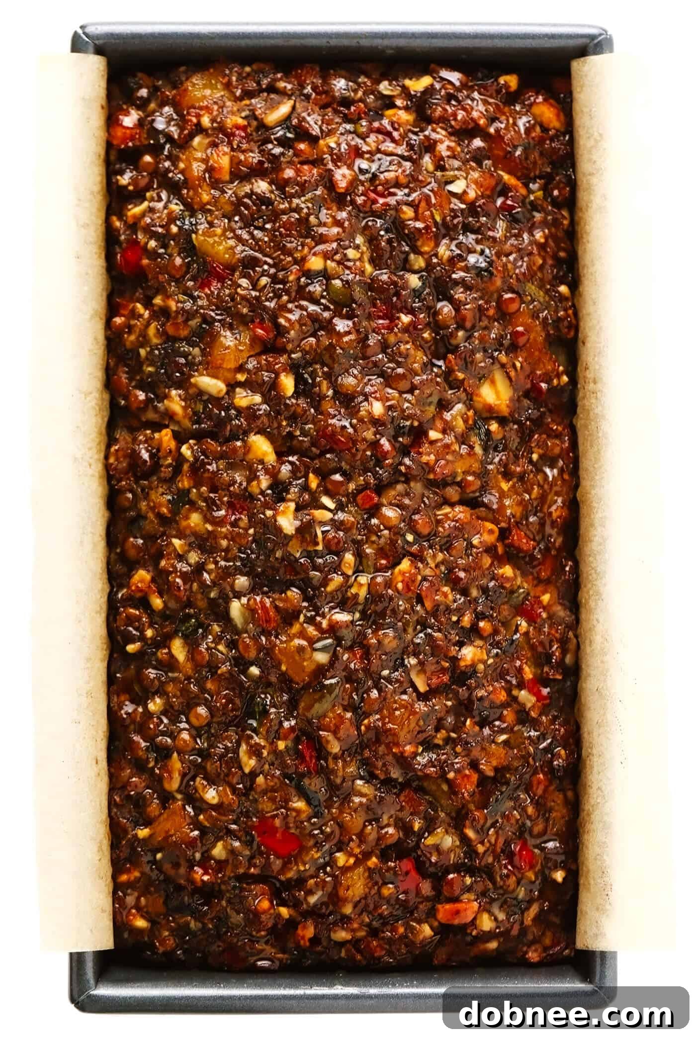 This Nut Roast recipe is packed with a deliciously sweet and savory blend of nuts, veggies, lentils, dried apricots and fresh rosemary and sage. It's easy to prep in advance, naturally gluten-free + vegetarian + vegan, and absolutely delicious served with cranberry sauce and/or gravy. Perfect for the holidays (especially Christmas, Thanksgiving or Easter) or Sunday dinner! | gimmesomeoven.com #nutroast #vegetarian #vegan #glutenfree #healthy #dinner #christmas #holiday Nut Roast in a Bread Pan, Ready for the Oven