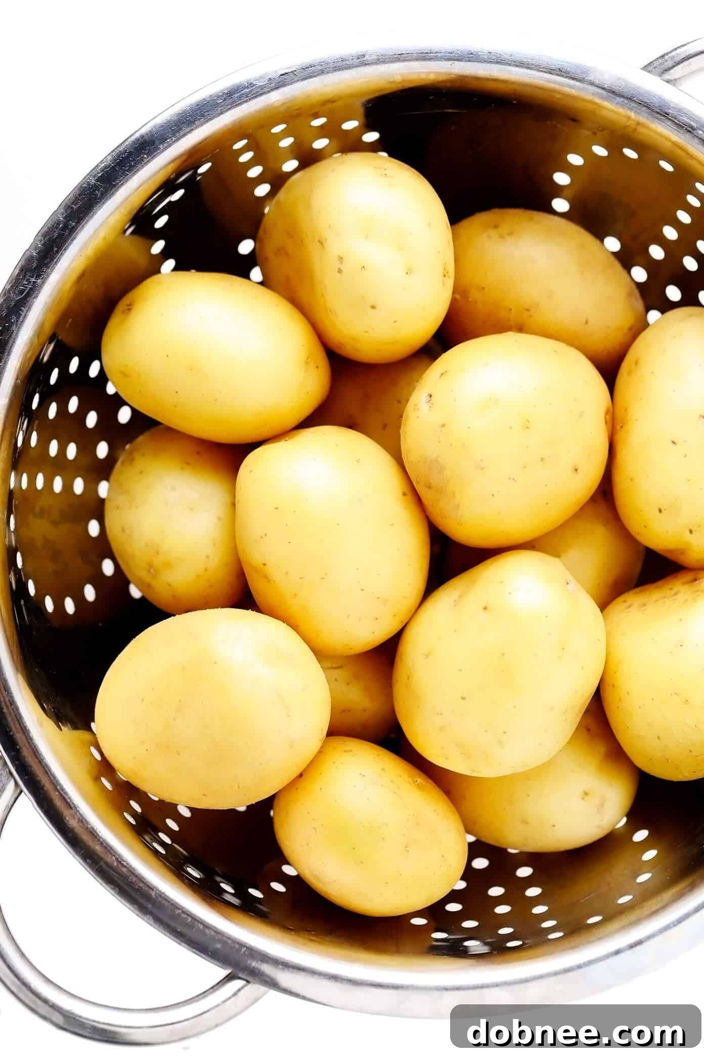 Close-up of small Yukon Gold potatoes, freshly washed and ready for boiling, forming the base of a delicious smashed potatoes recipe.