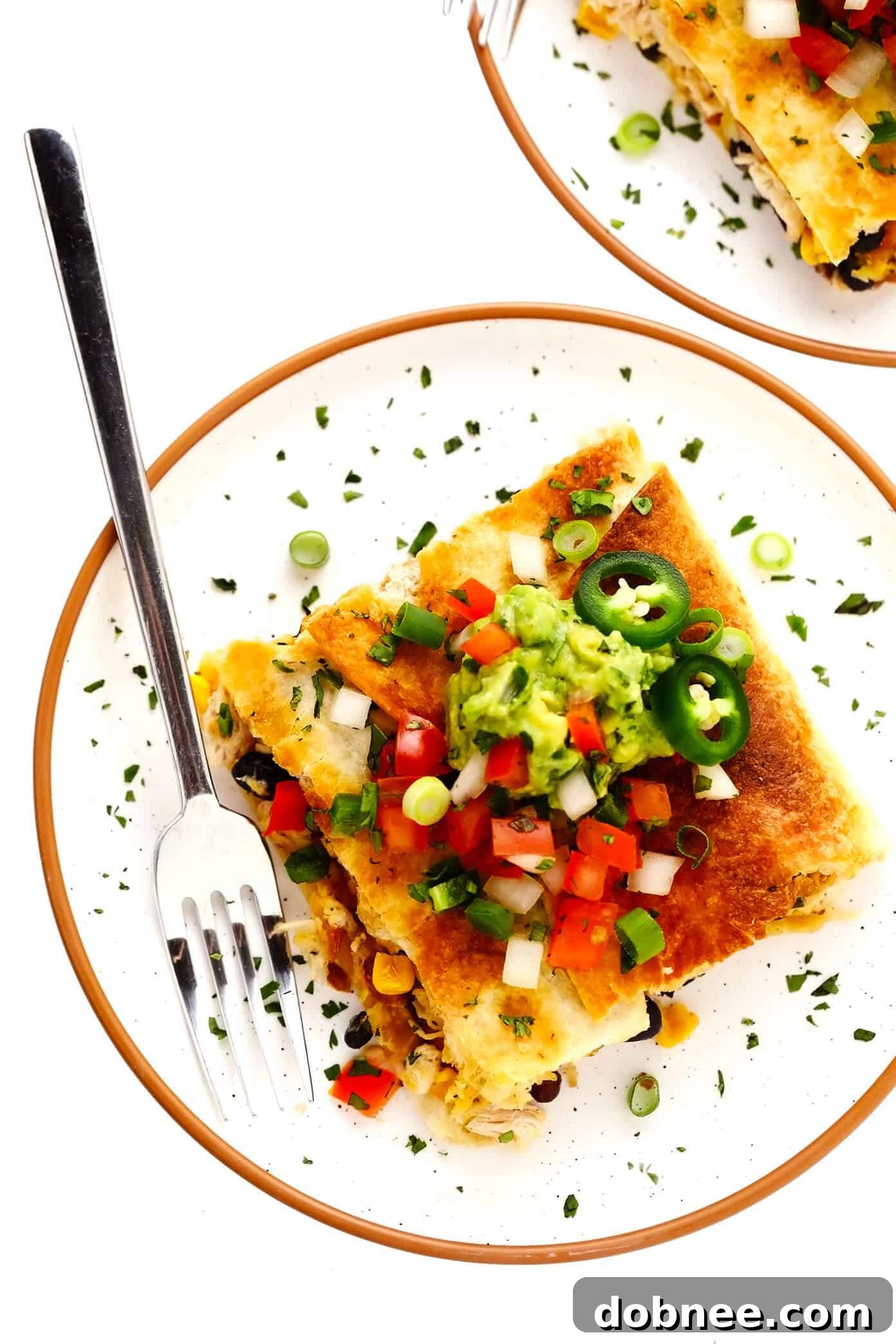 An individual serving of Chicken Sheet Pan Quesadilla, perfectly plated with a side of guacamole and pico de gallo.