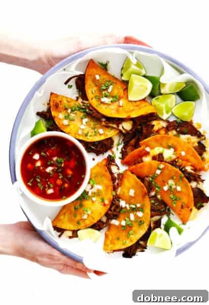 Birria Tacos (Quesotacos) plated with dipping broth