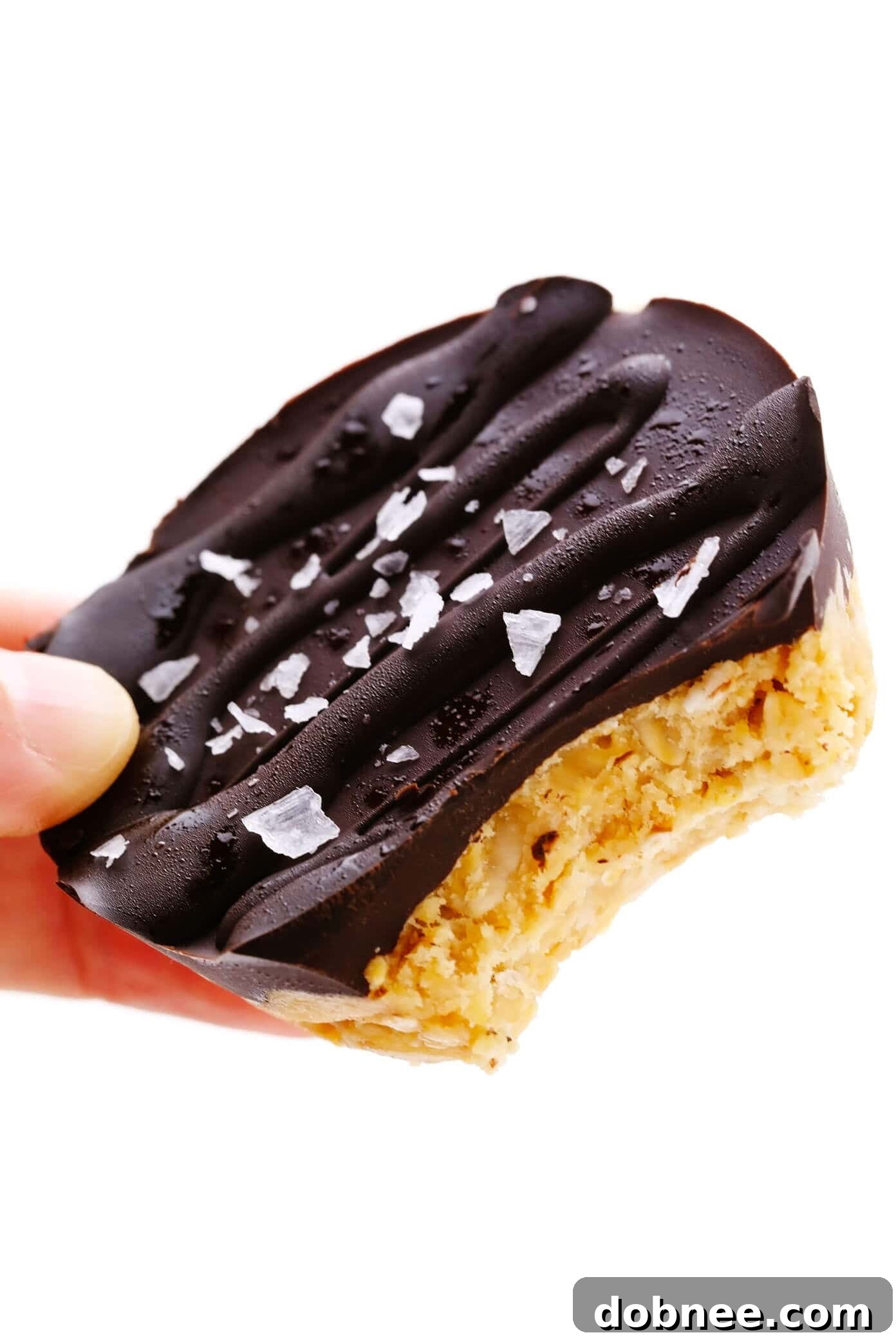 Holding a Salted Chocolate Peanut Butter Oat Cup