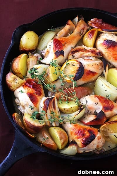 Platter of Apple Cider Baked Chicken with fresh thyme garnish