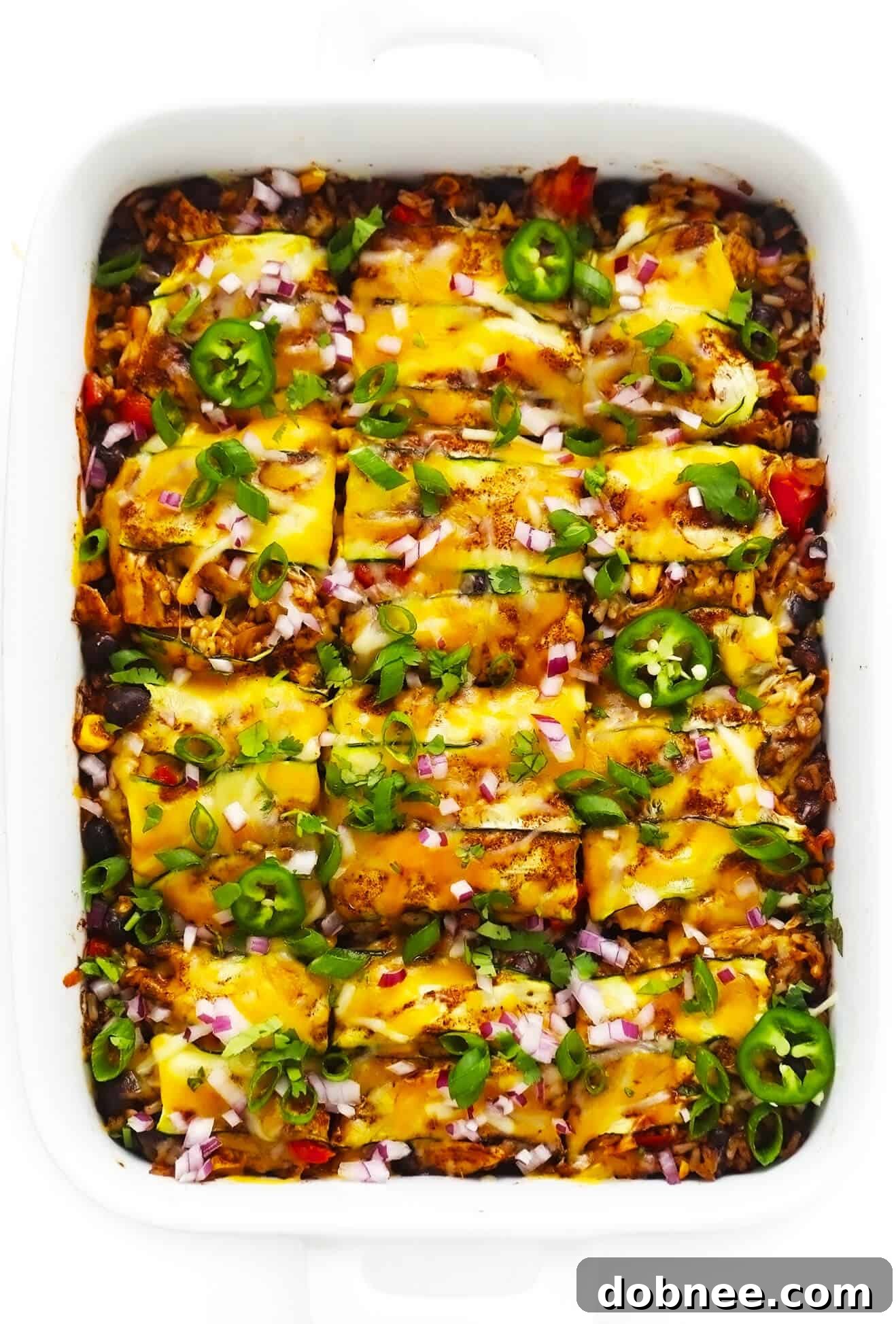 Golden-brown Zucchini Enchilada Casserole fresh out of the oven, bubbling cheese and rich sauce visible in a baking dish