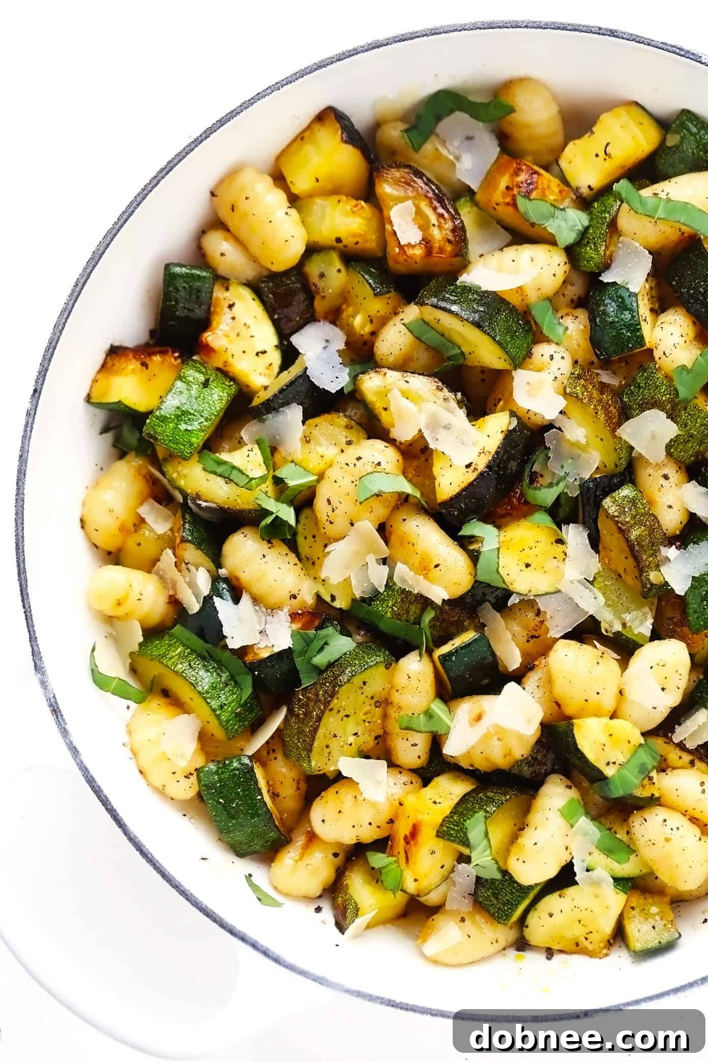 Lemon Basil Gnocchi with Zucchini in a bowl, garnished with fresh basil