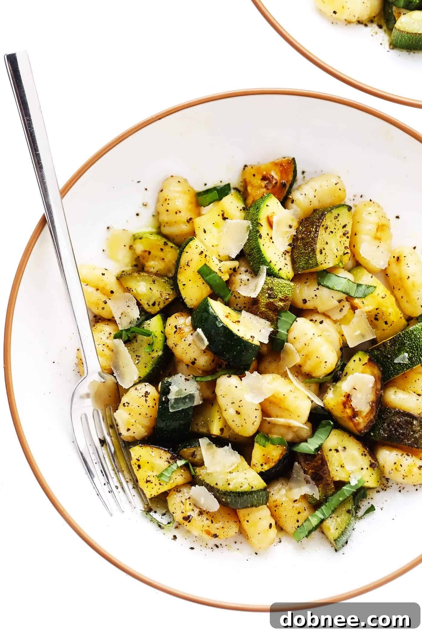 Serving bowl filled with Lemon Basil Gnocchi with Zucchini, ready to be enjoyed