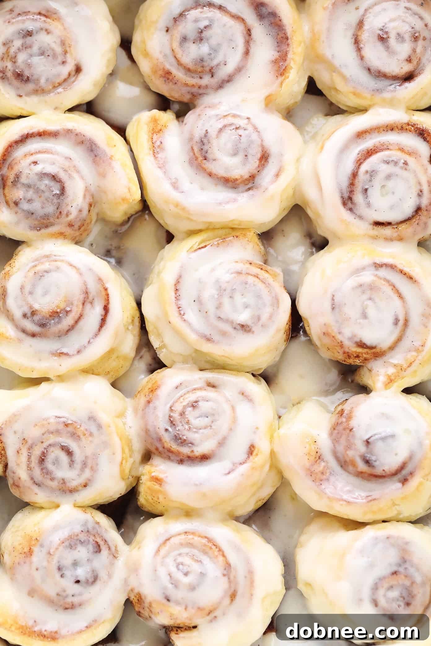 Closeup of Golden Puff Pastry Cinnamon Rolls with White Icing