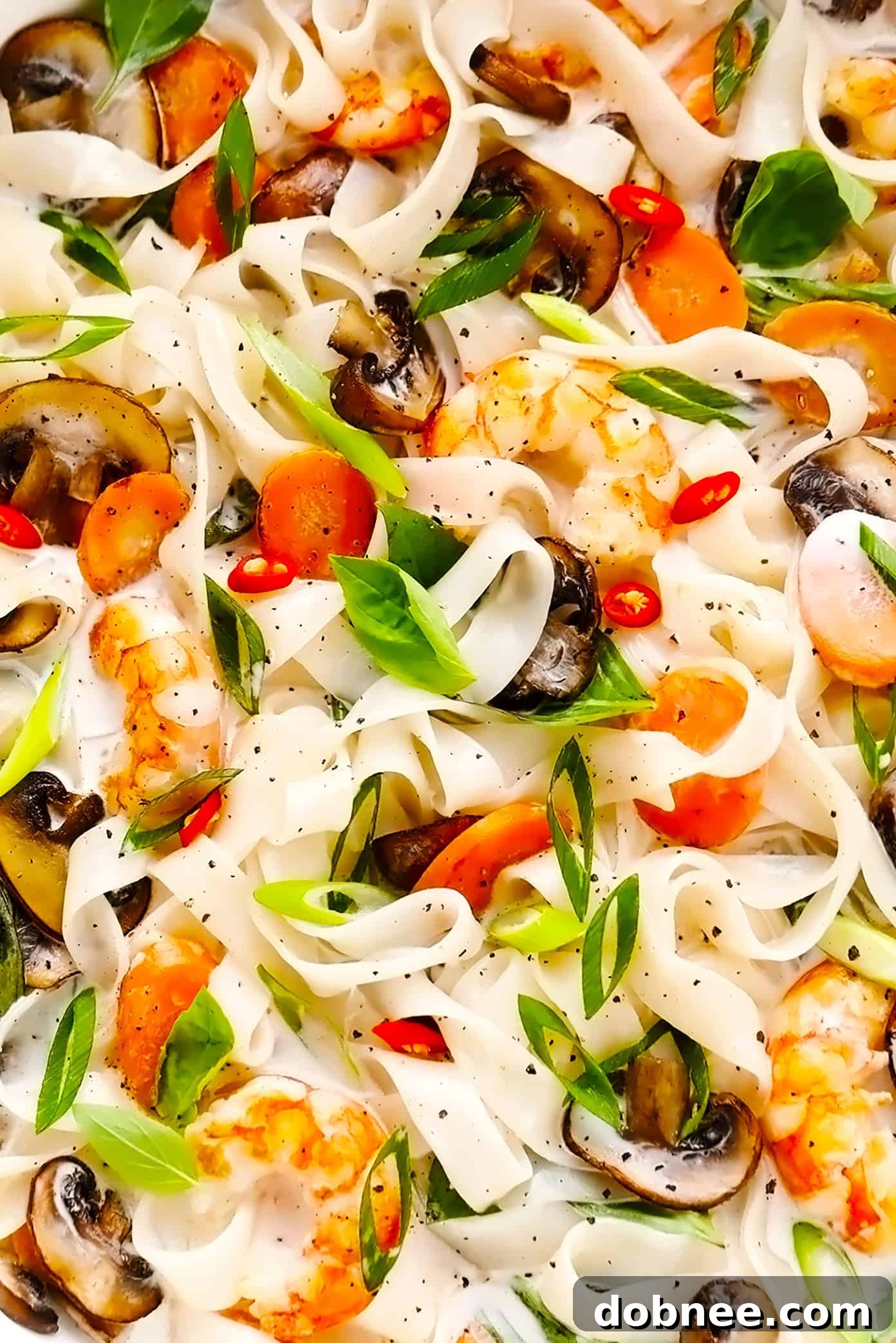 Close-up of Lemongrass Coconut Noodles with Shrimp and Fresh Basil