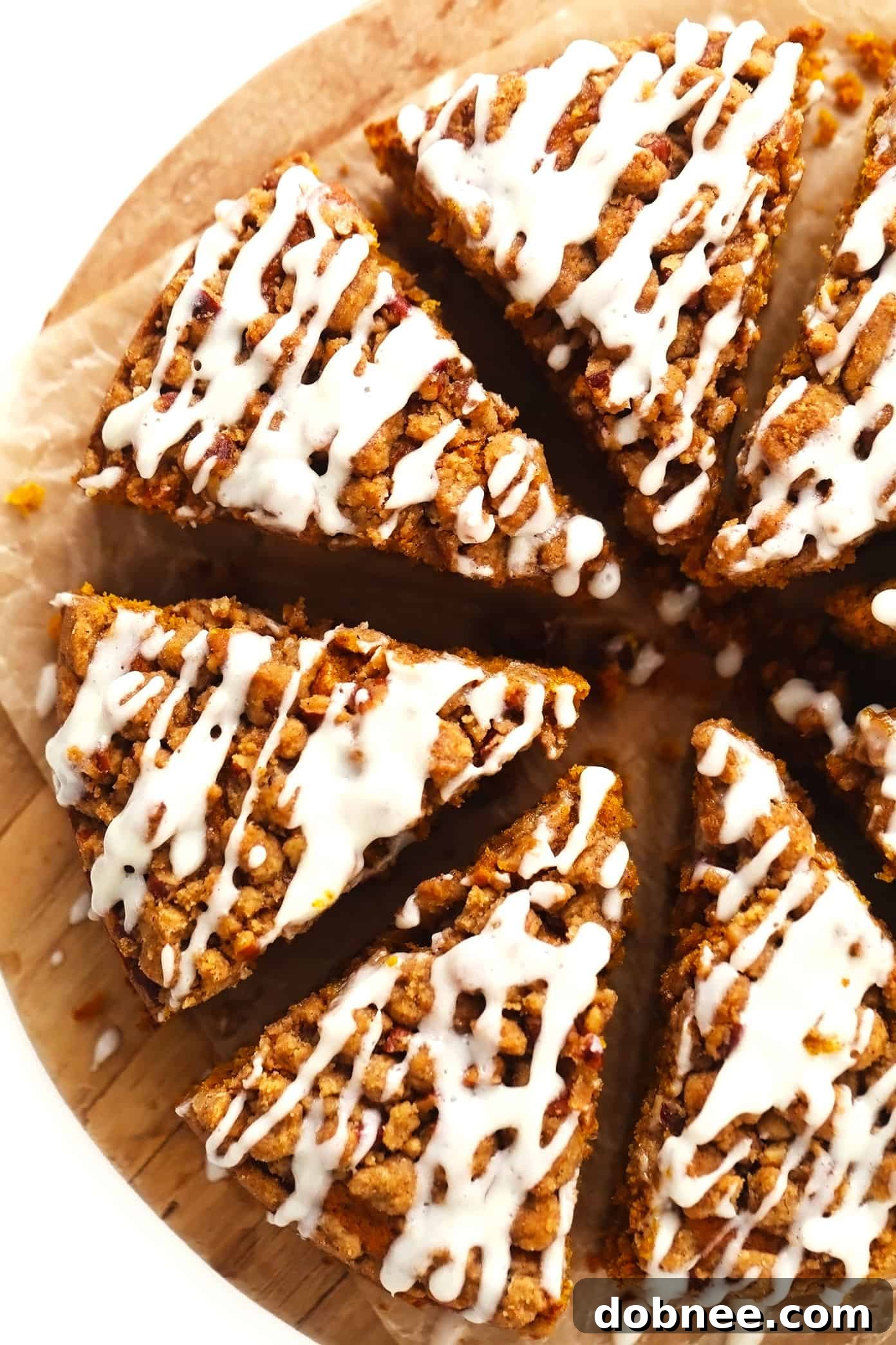 Slices of pumpkin coffee cake with streusel and cream cheese drizzle