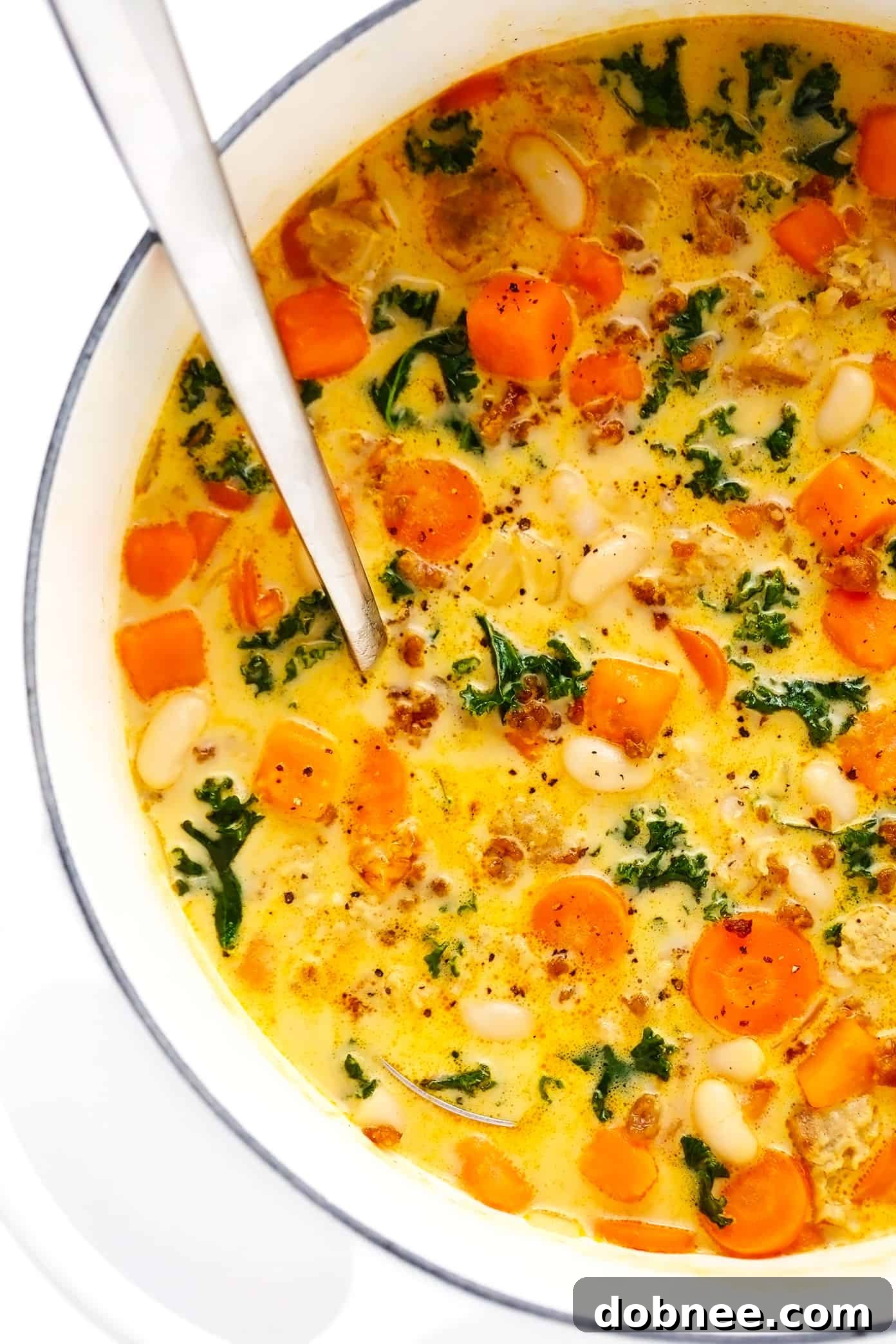 Creamy Sweet Potato and Sausage Soup, a hearty and flavorful soup perfect for fall and winter comfort food.