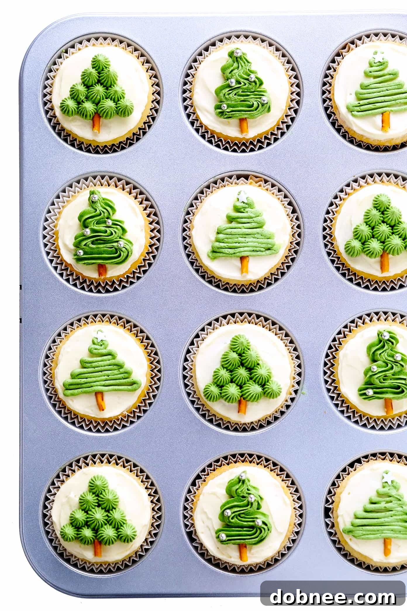 Adorable Christmas Tree Cupcakes decorated with green frosting and sprinkles, a perfect holiday dessert.