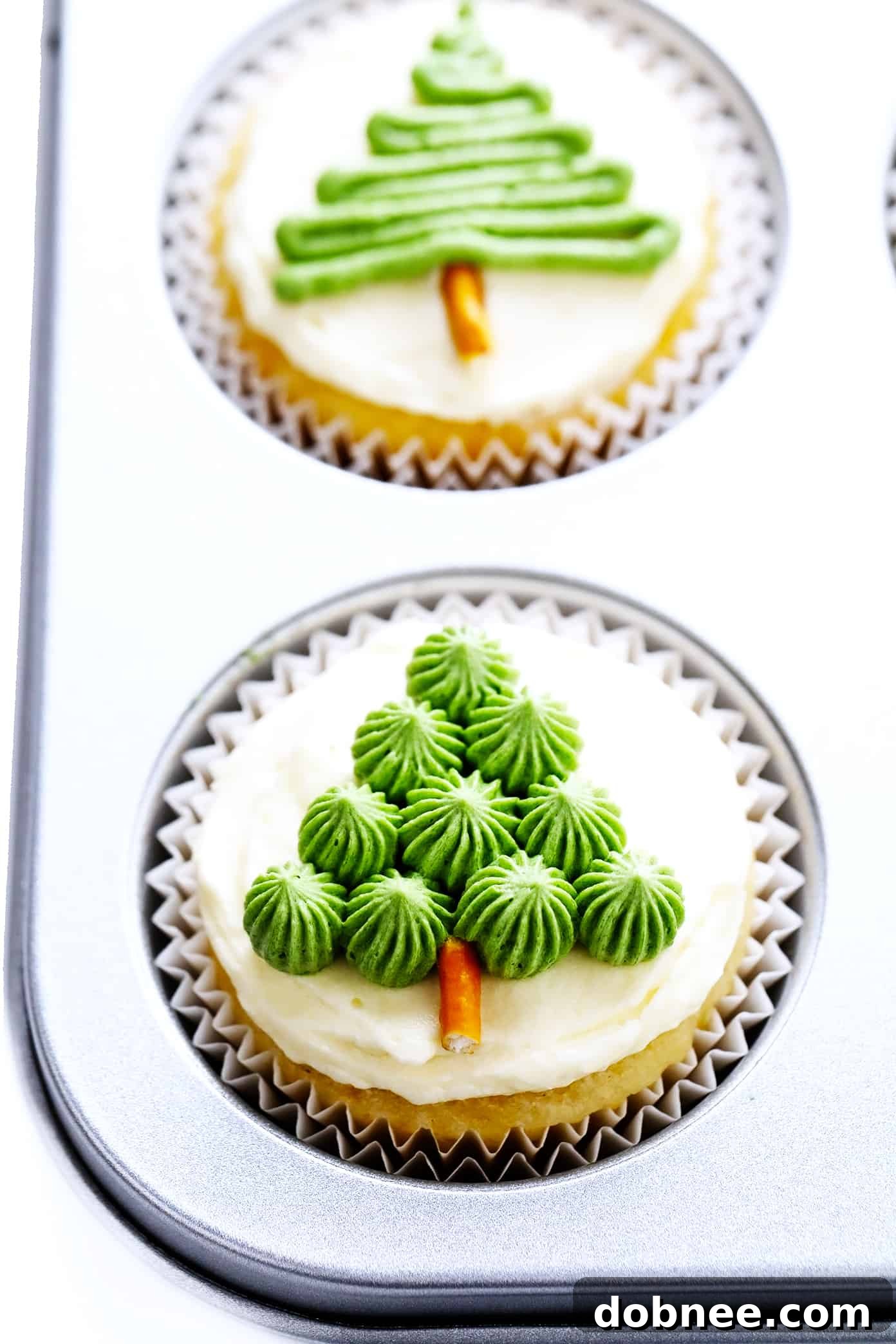 Freshly baked vanilla cupcakes in a baking pan, ready for festive Christmas decorating.