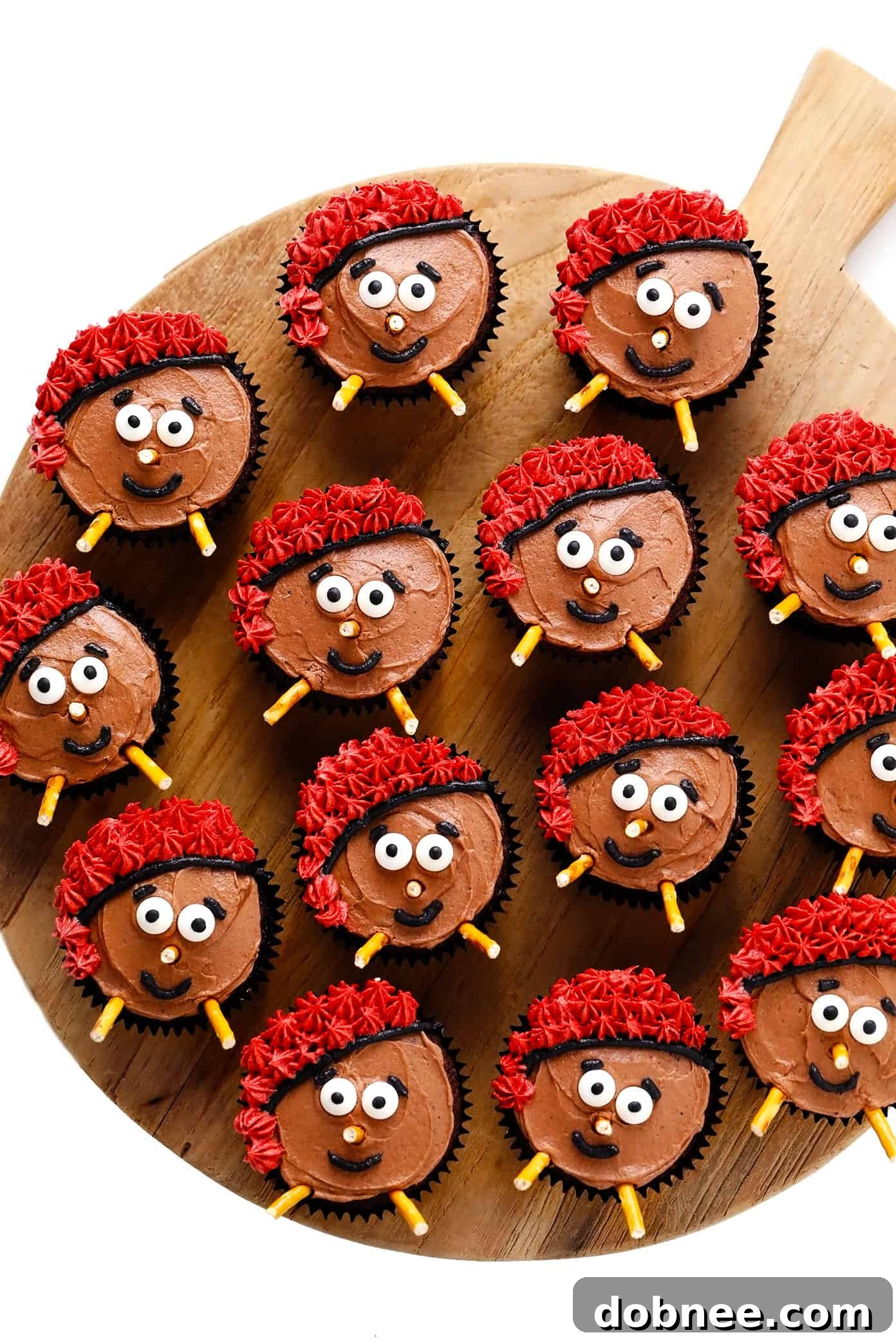 A serving tray filled with an assortment of Caga Tió Christmas cupcakes