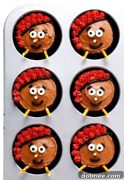 Caga Tió Cupcakes with red hats and candy eyes on a plate