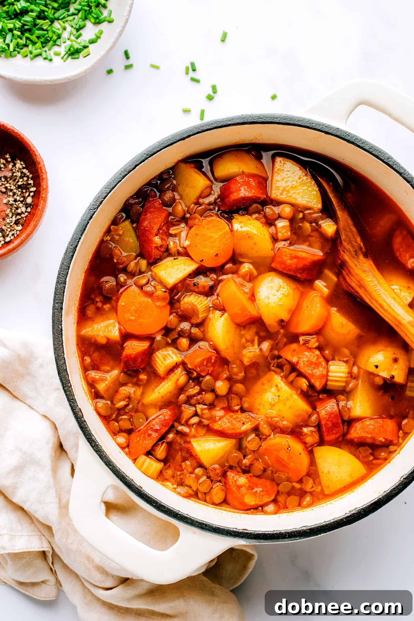 Large stockpot filled with simmering Spanish Chorizo Lentil Stew, rich in color and texture