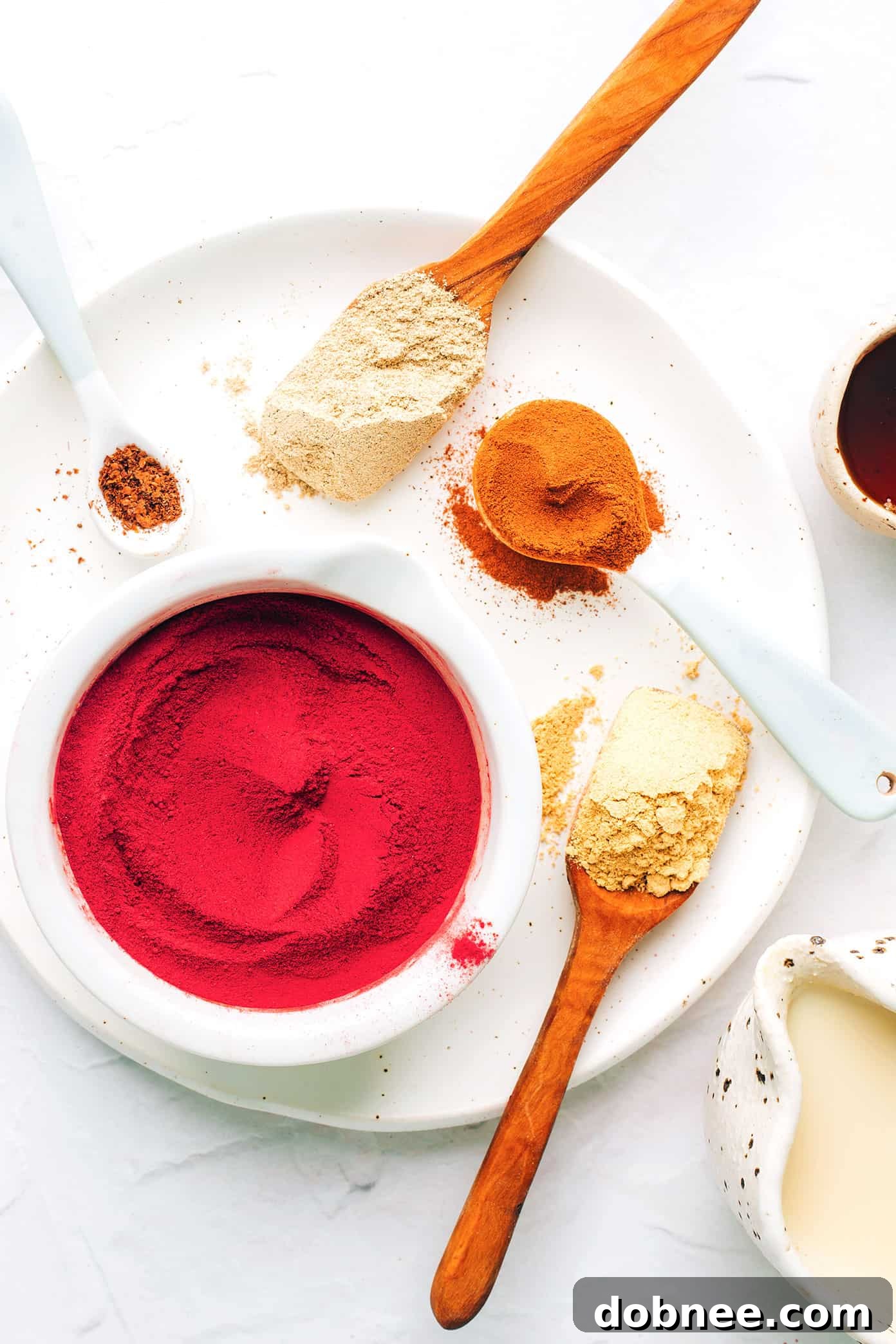 Key ingredients for a Pink Beetroot Latte: beetroot powder, cinnamon, ginger, cardamom, and cloves.