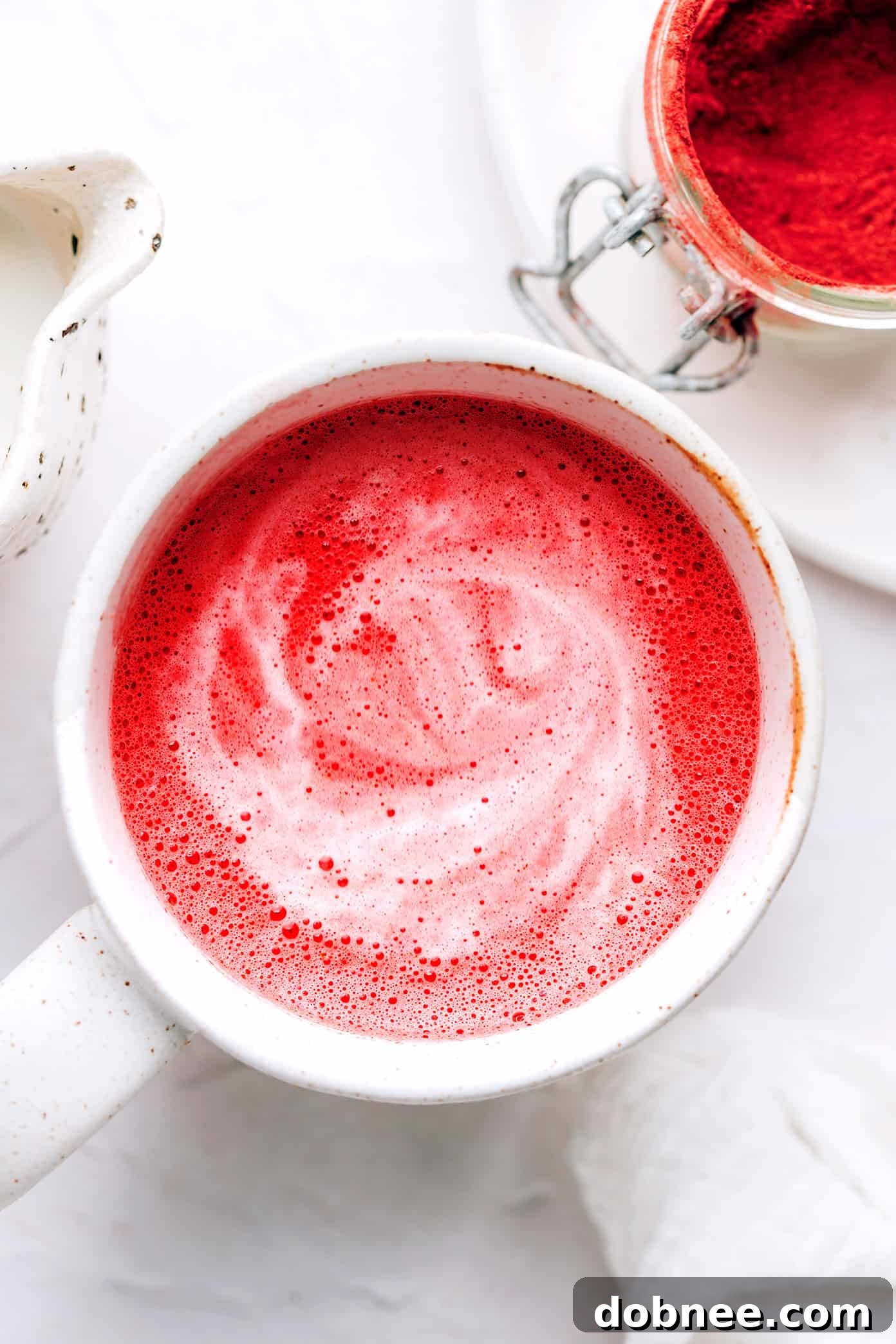 Cozy Hot Pink Beetroot Latte in a clear glass mug, ready to be enjoyed.