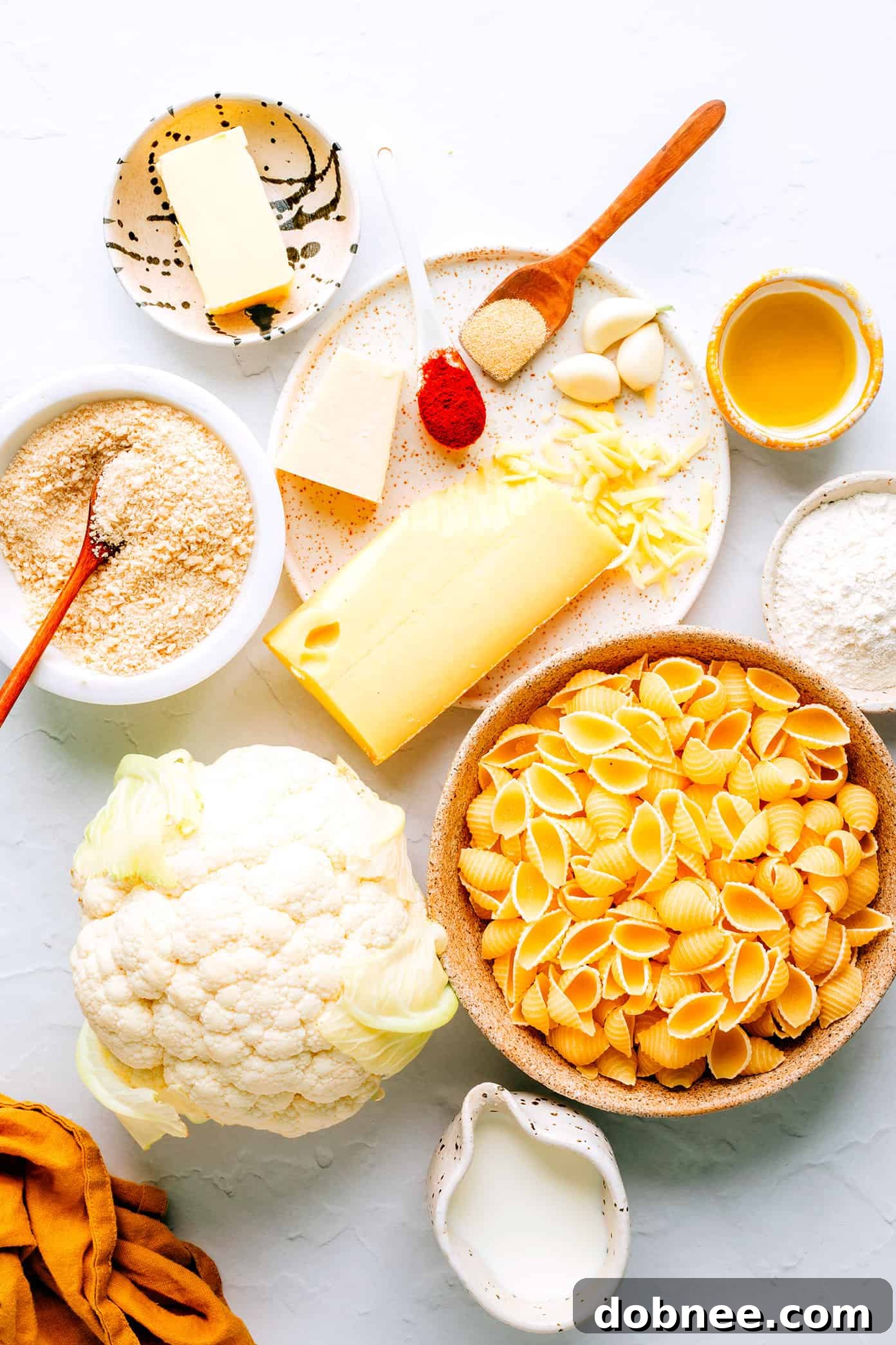 Essential ingredients for a delicious Roasted Cauliflower Mac and Cheese Ingredients laid out for Roasted Cauliflower Mac and Cheese preparation