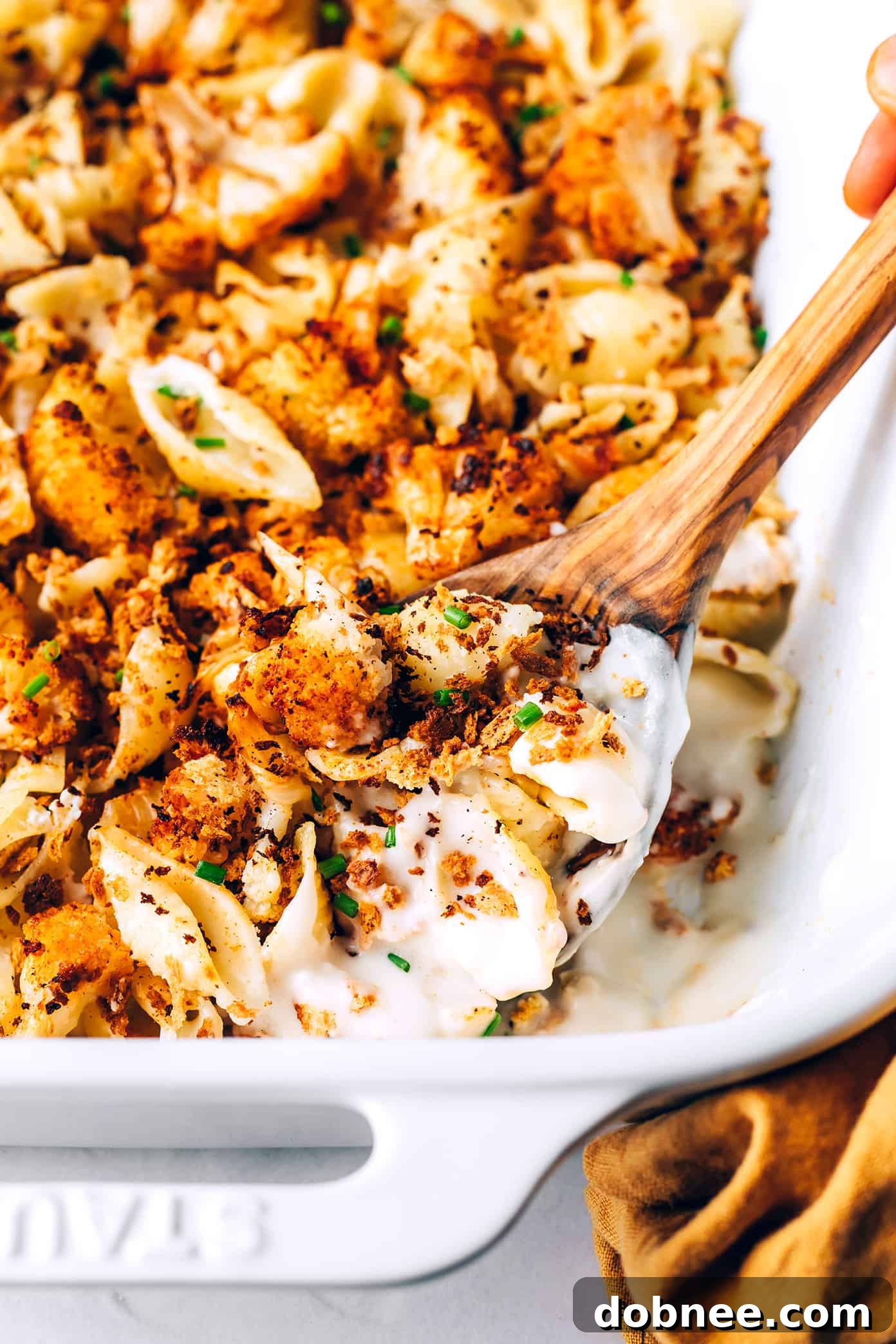 Golden and cheesy: a close look at this delicious comfort food Close-up of bubbling Roasted Cauliflower Mac and Cheese in a baking dish