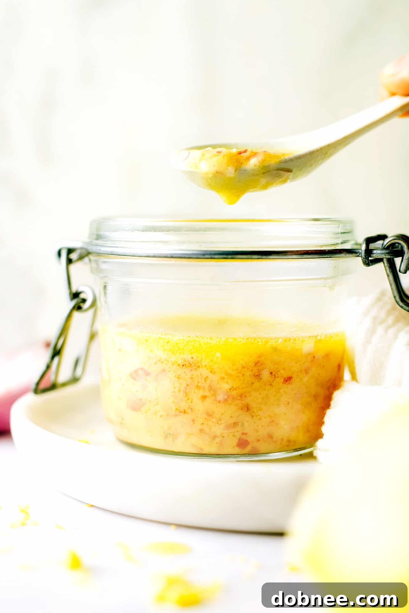 Homemade Shallot Vinaigrette in a jar, with fresh shallots visible