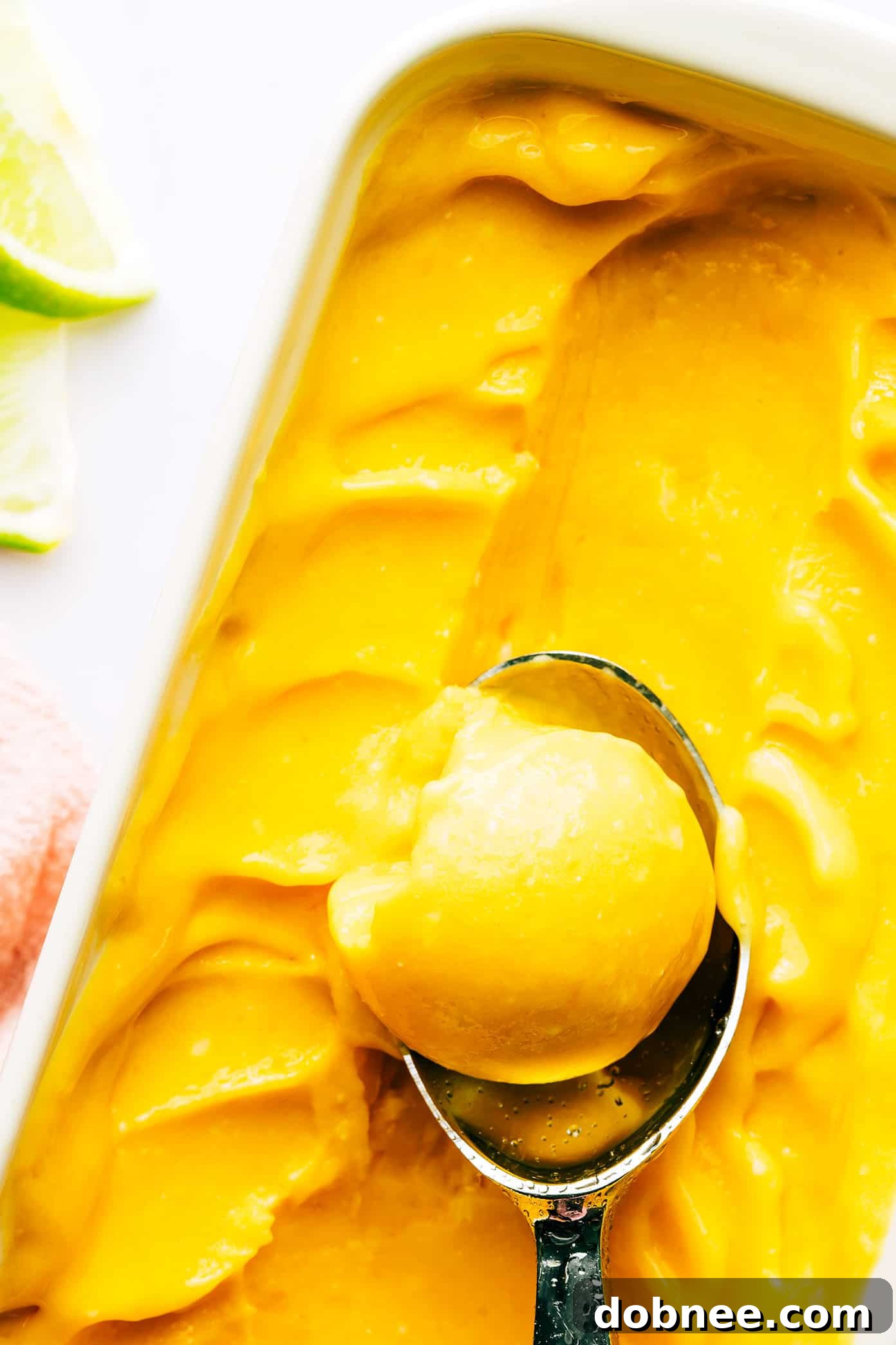 Scoops of Mango Lime Sorbet in a pan, ready to be served