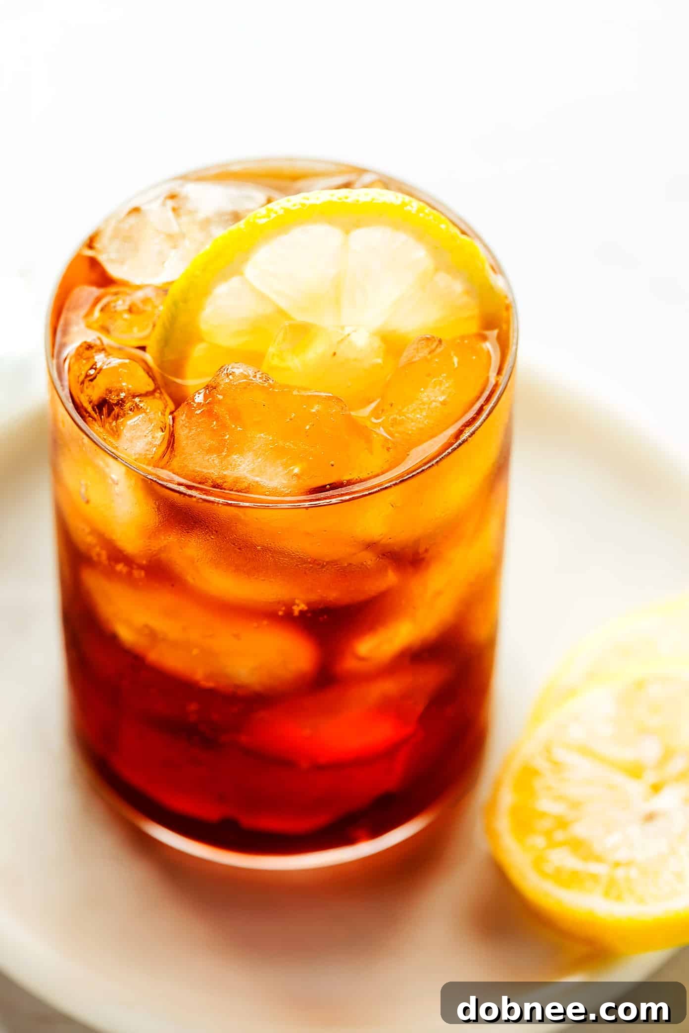A vibrant glass of Cold Brew Tonic with a lemon slice and ice cubes, ready to be enjoyed