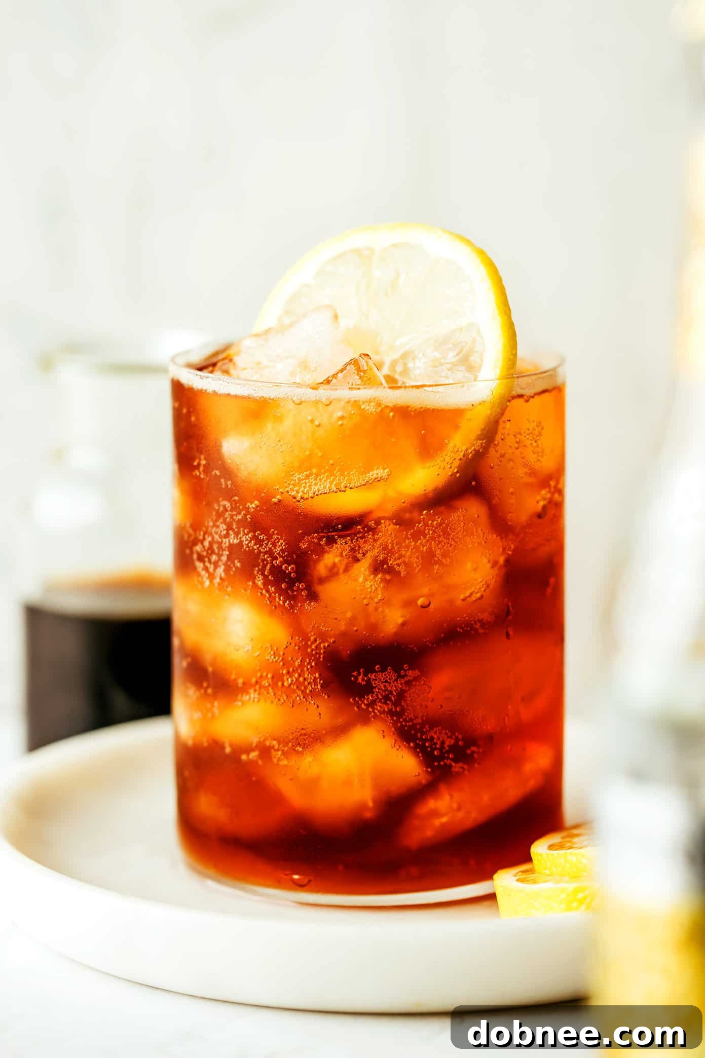 A perfectly prepared Cold Brew Tonic, garnished with a lemon slice, sitting in a stylish glass
