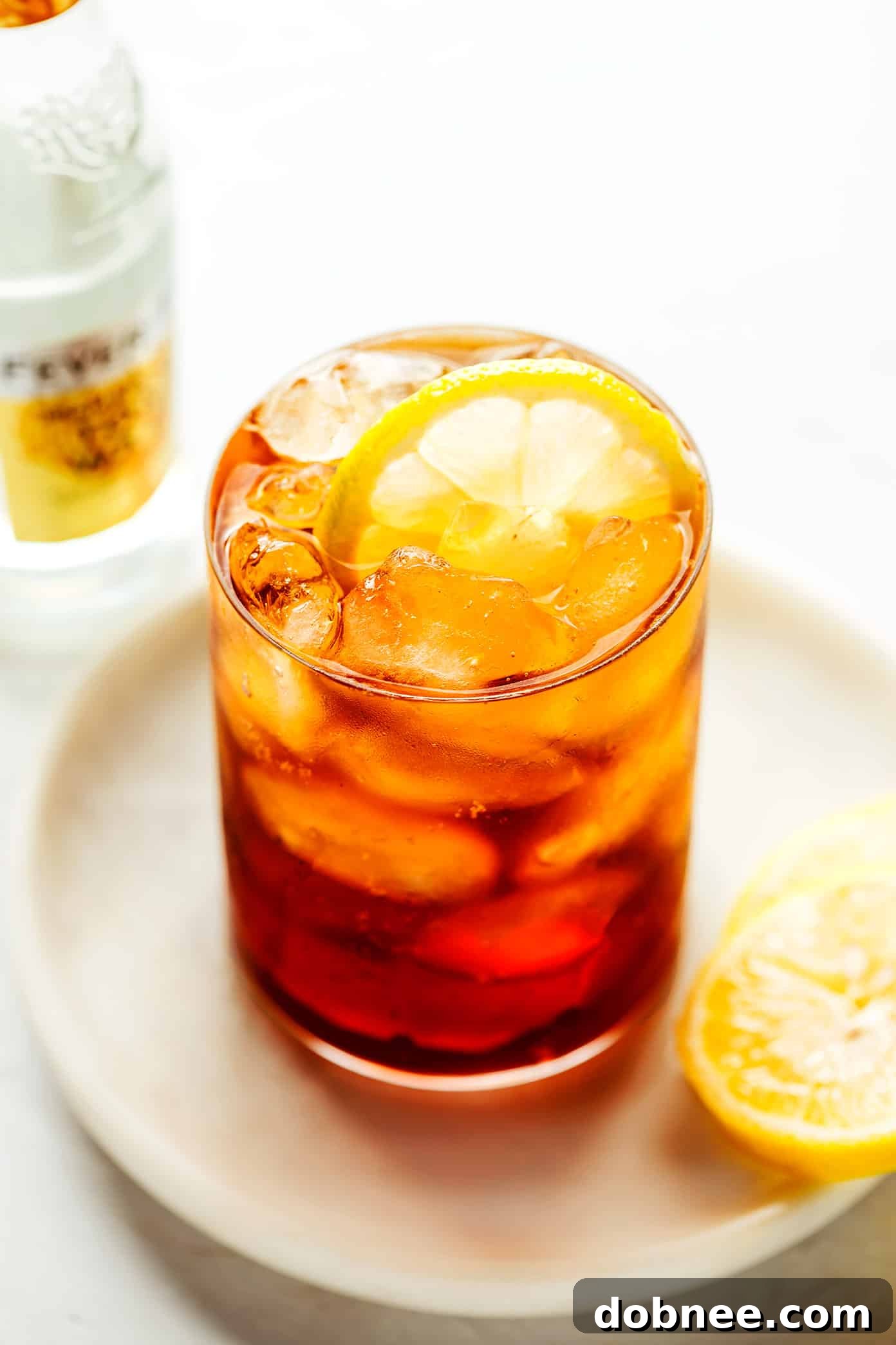 A close-up shot of a Cold Brew Tonic showing the bubbles and the texture of the ice and lemon