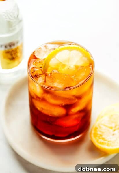 A refreshing Cold Brew Tonic in a glass, with a slice of lemon