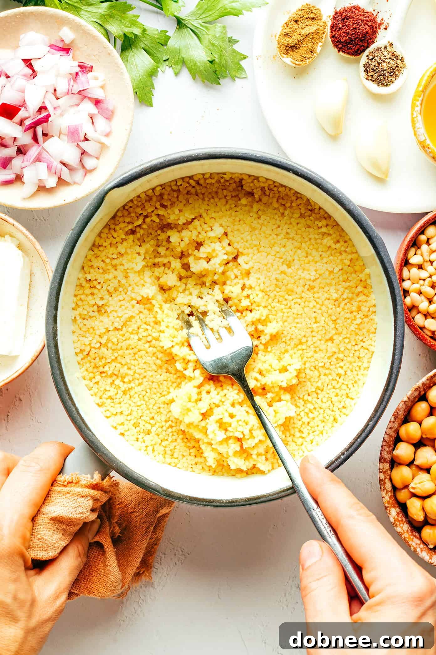 Making couscous - Step-by-step image of cooking couscous for the salad, showcasing the simple preparation process before mixing with fresh ingredients.