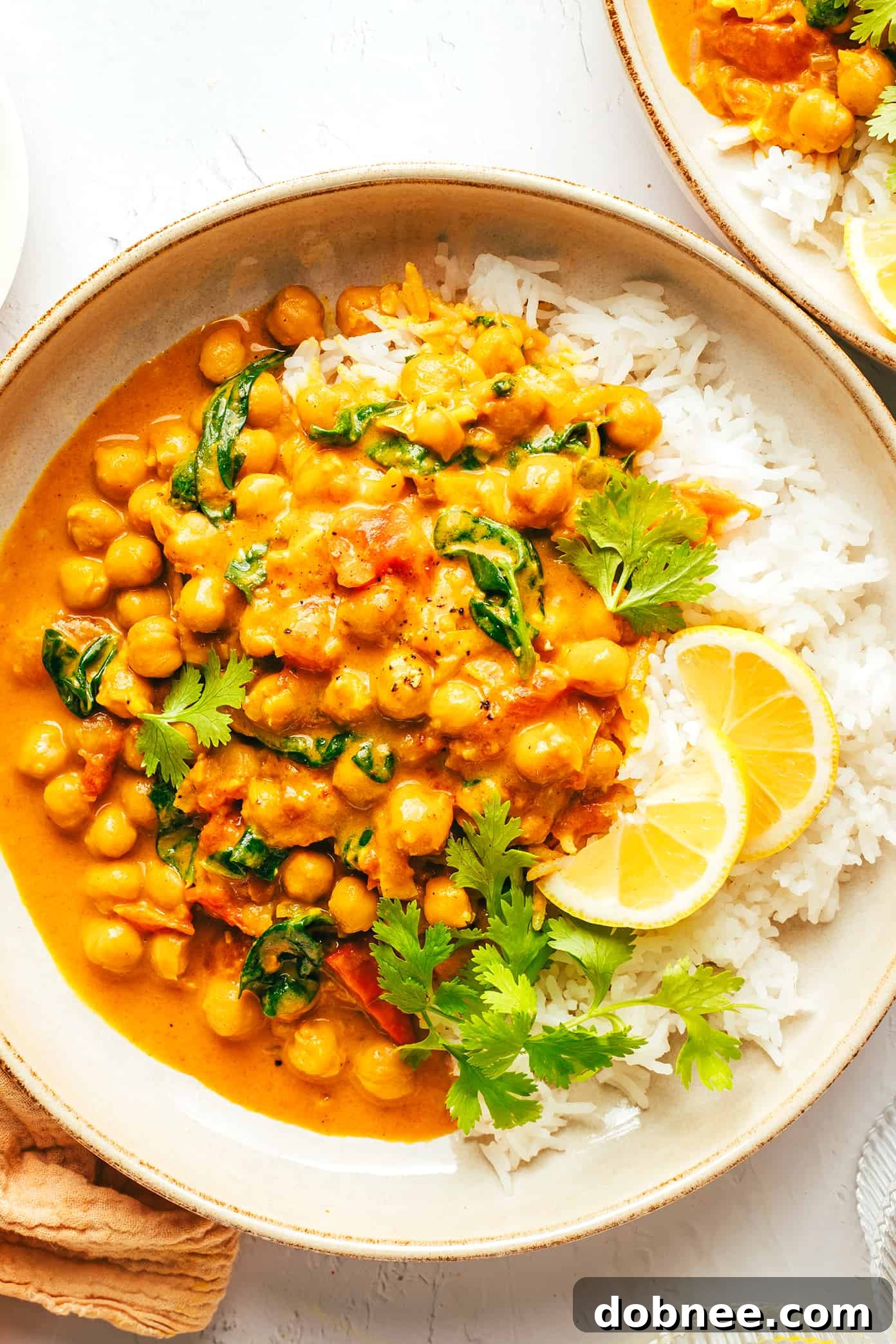 Easy Chickpea Curry Served with Rice and Lemon Wedges