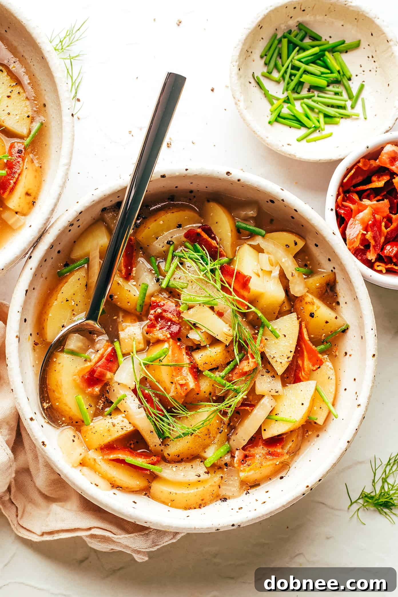 Potato Bacon Fennel Soup in Bowl - Garnish with chives and fennel fronds