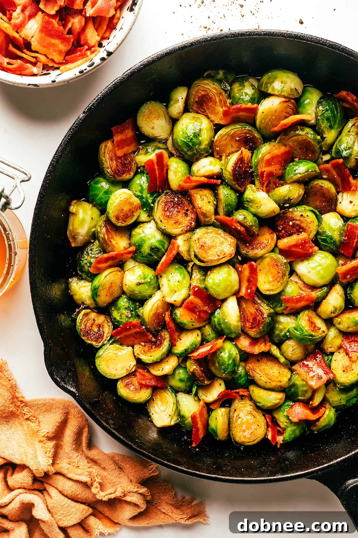 Bacon Brussels Sprouts with Hot Honey simmering in a large skillet.