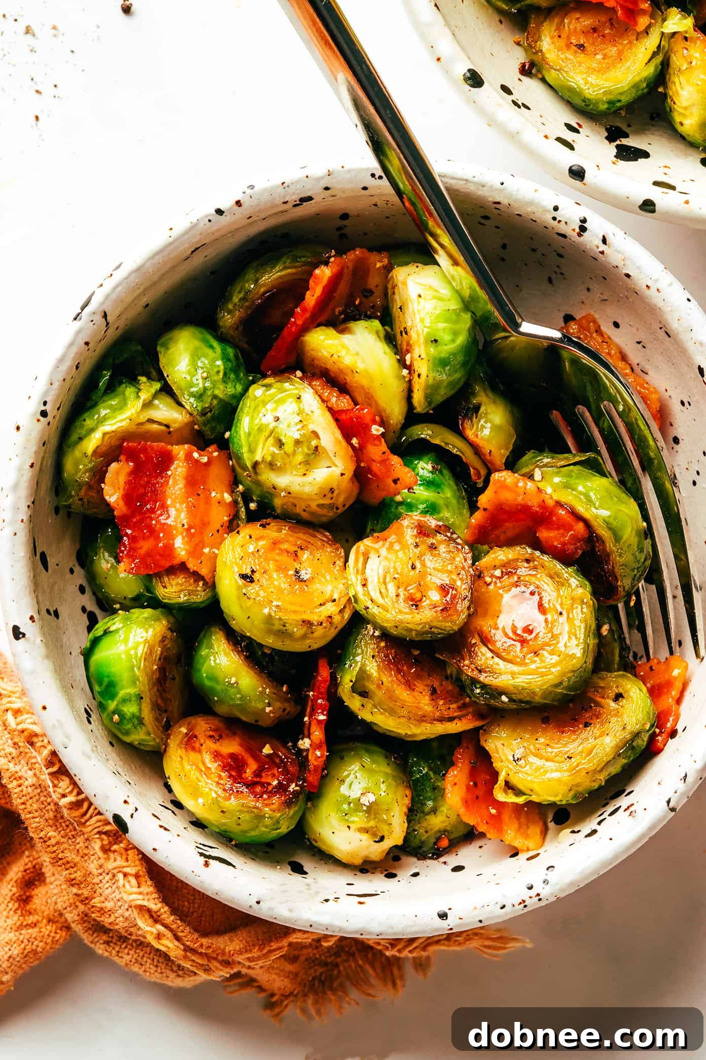 A serving bowl filled with Bacon Brussels Sprouts with Hot Honey, ready to be enjoyed.
