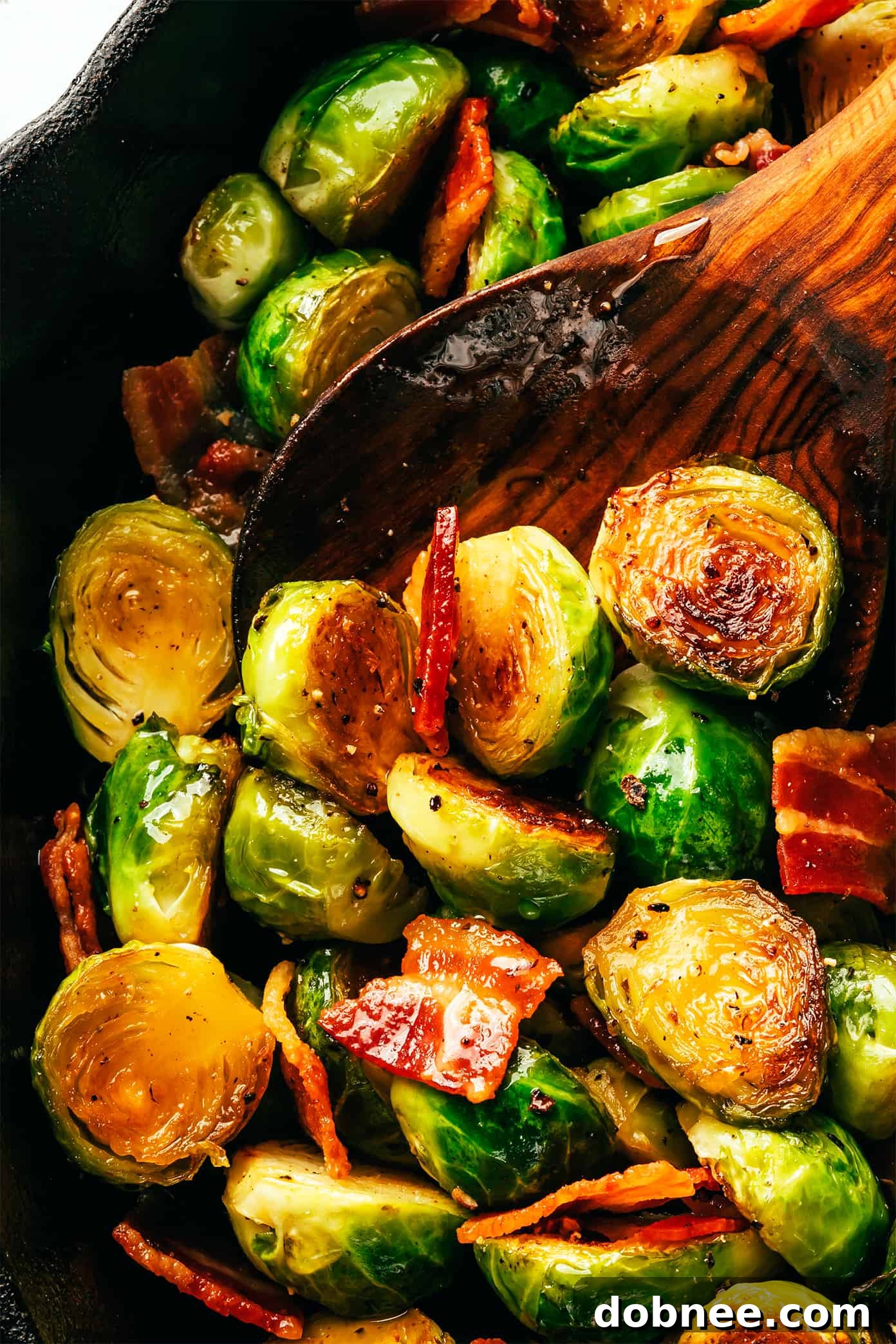 A close-up shot of Bacon Brussels Sprouts with Hot Honey, showing the crispy bacon and caramelized sprouts.