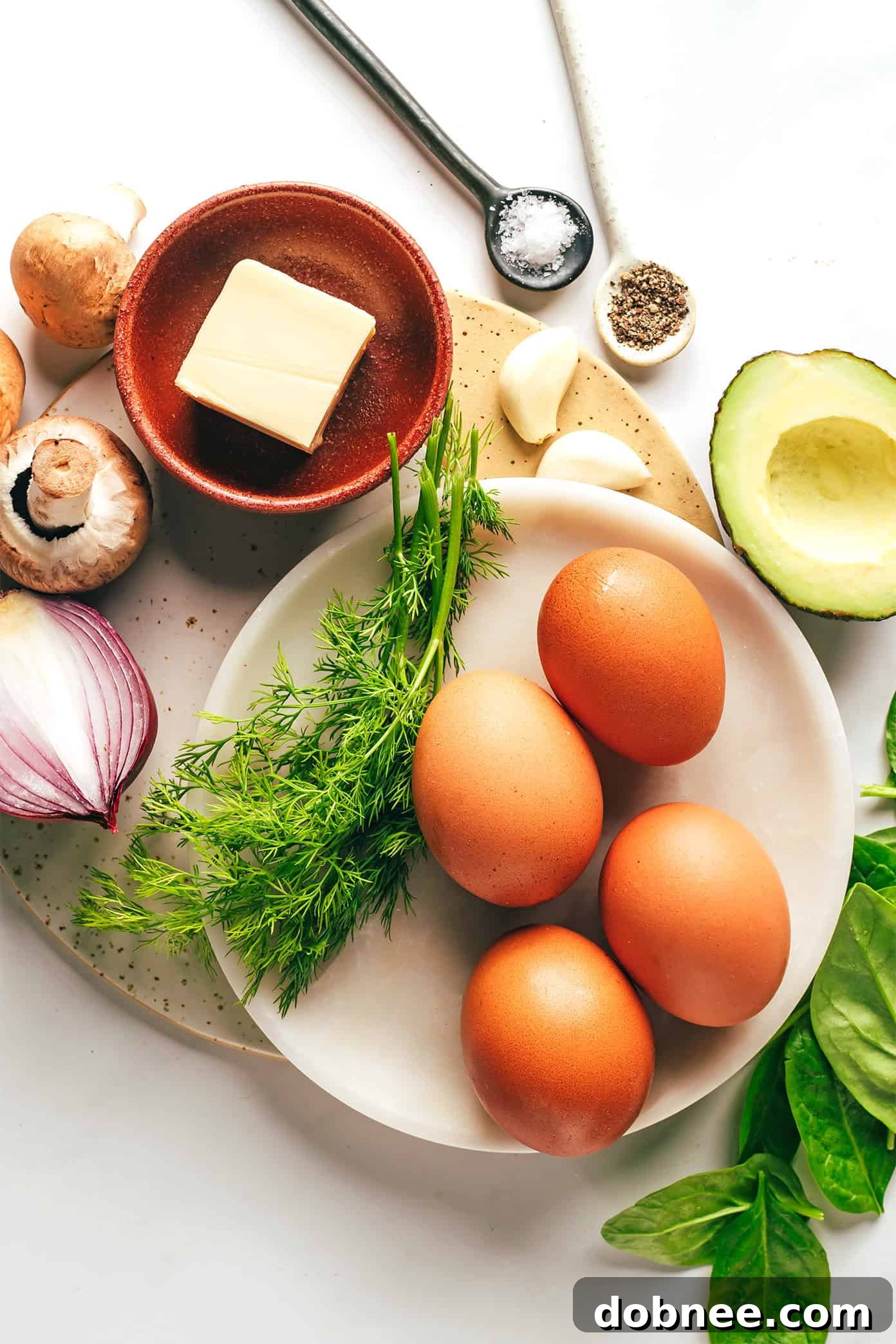 A close-up of the cooked spinach mushroom egg scramble, showing the creamy eggs and vibrant vegetables.